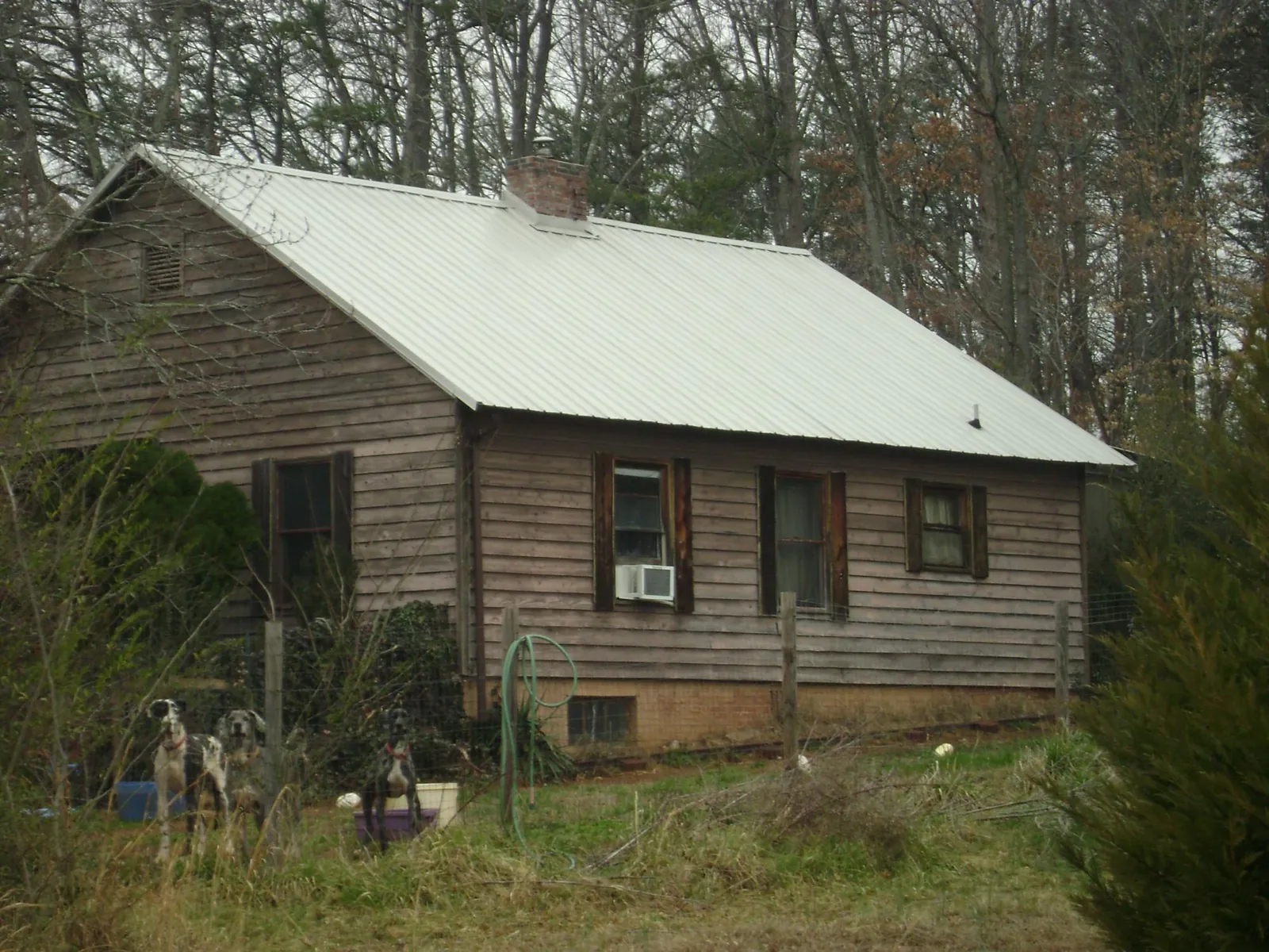 White metal roof on an old wood sided farmhouse, from a Metal Roof Installation job in Pocono Lake
